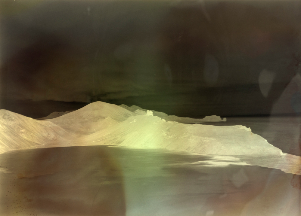 Negative image of Jan Mayen, showing coloured chemical swirls